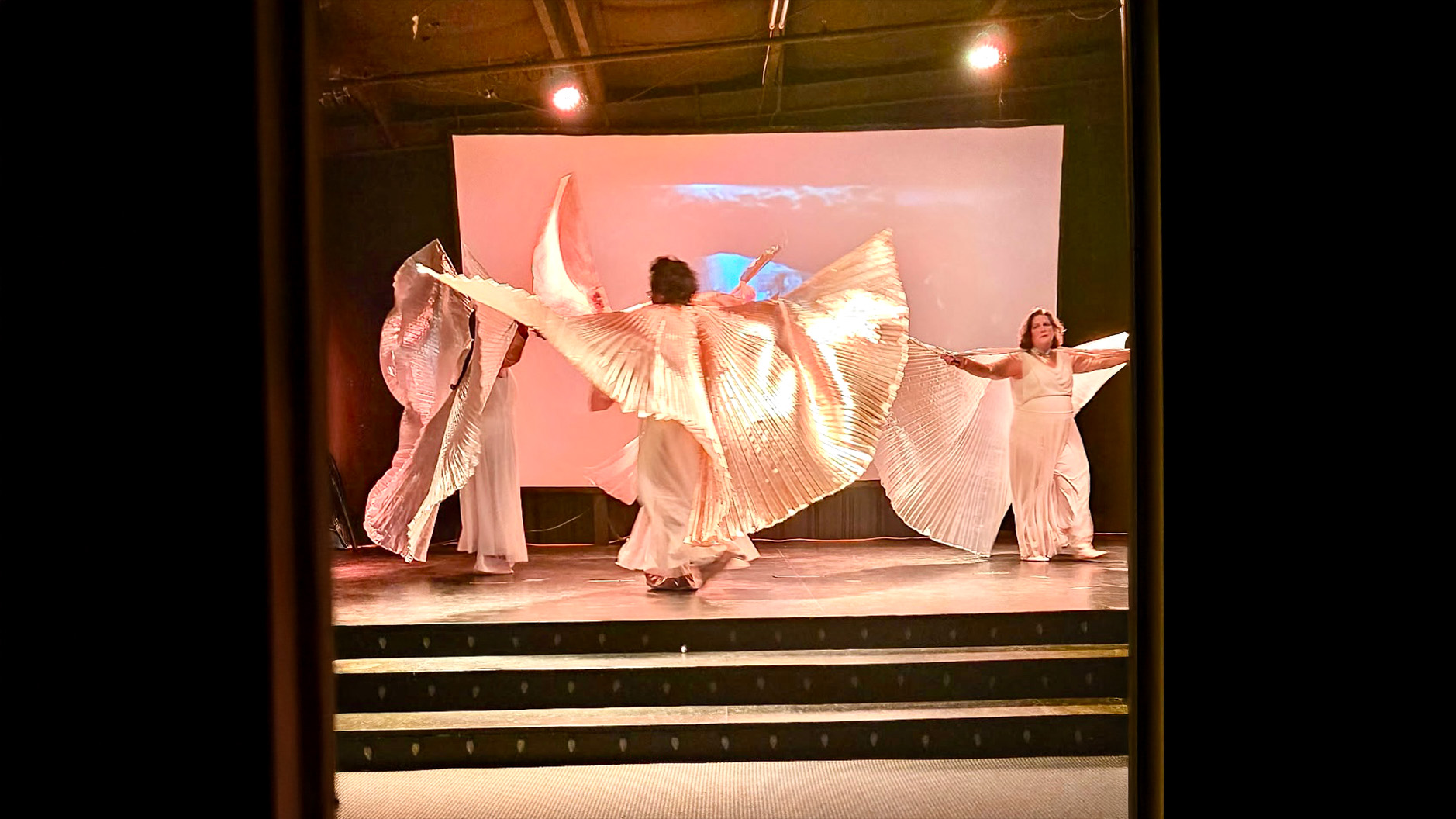 A Warriors Stance dancers with angel costumes on stage dancing