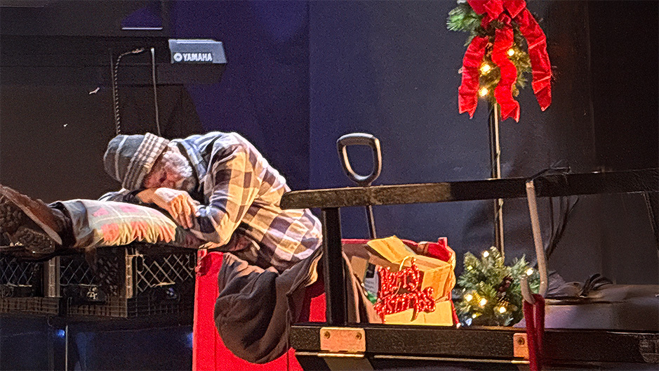 Homeless man on stage sad and over his pillow